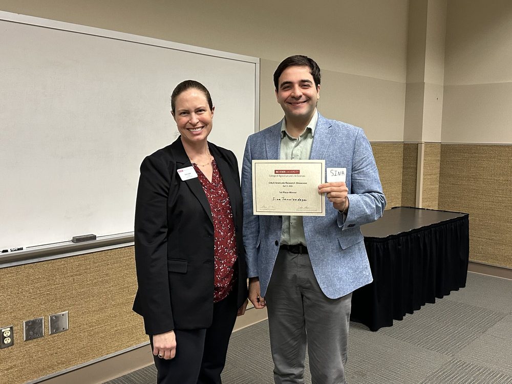 Sina Jamalzadegan holding the CALS Graduate Research Showcase first place certificate