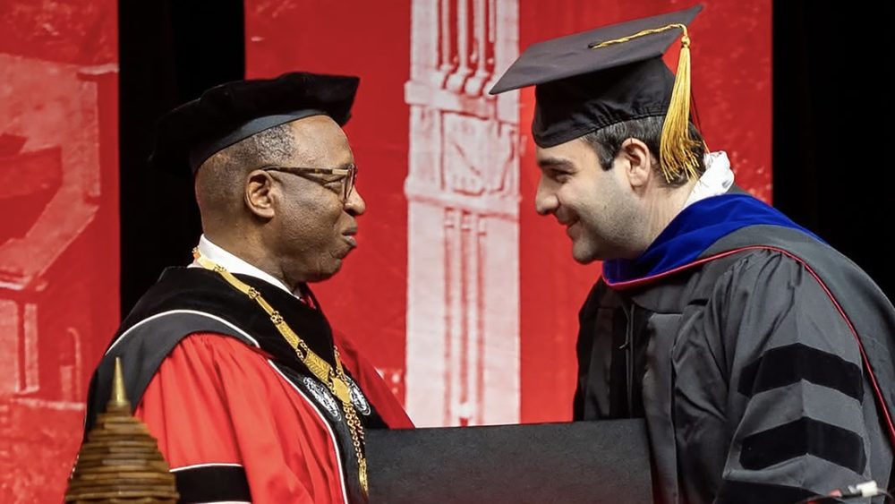 Sina Jamalzadegan receiving his doctoral hood from the NC State chancellor